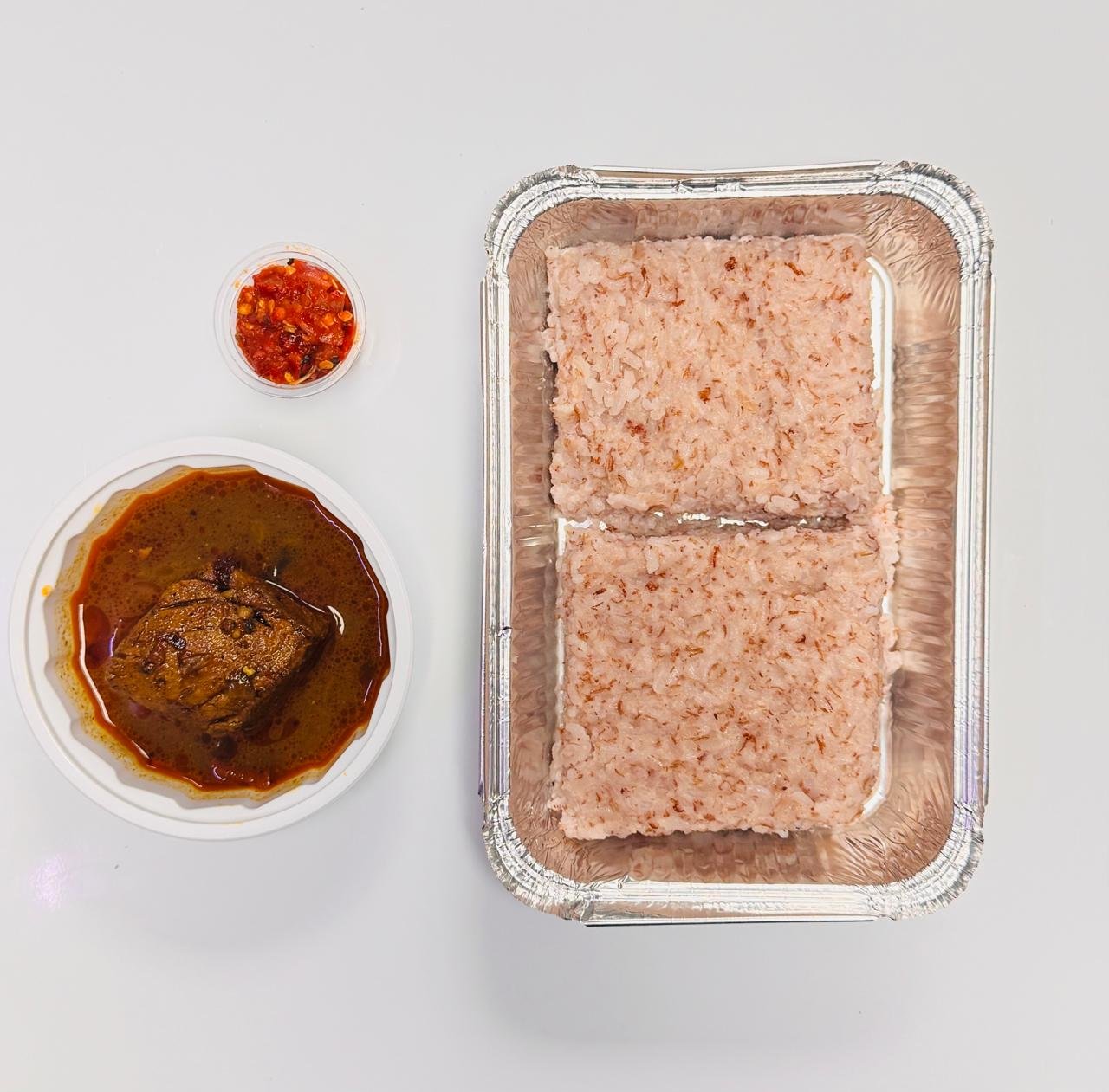 Traditional Sri Lankan Kiribath milk rice with fish curry
